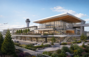 Inside SEA Airport’s New $399M, 145,000-Sq-Ft C Concourse Expansion Exterior view of Seattle-Tacoma International Airport’s new C Concourse Expansion, featuring a spacious four-story atrium with abundant natural light, modern seating areas, retail shops, dining venues, public art installations, and large windows overlooking the airfield. The contemporary design reflects Pacific Northwest forest landscapes, creating an open and welcoming environment for travelers.