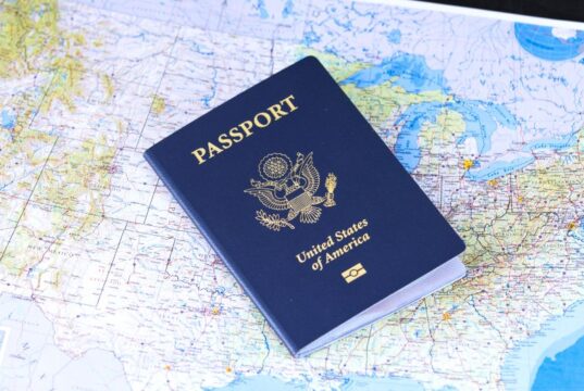 10-Year US Visa: The Rules Nobody Bothers to Read US visa stamp displayed over a world map, representing international travel and 10-year multiple-entry US tourist visa rules.